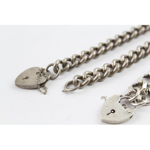 2033 - Two sterling silver gate bracelets with heart padlock clasps - approx. gross weight 53g