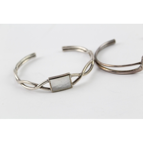 2036 - Three sterling silver bangles, one Celtic, one mother of pearl and one twist - approx. gross weight ... 