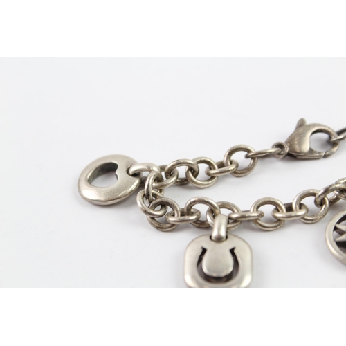 2040 - A Tiffany & Co sterling silver charm bracelet with cut work charms - approx. gross weight 41g