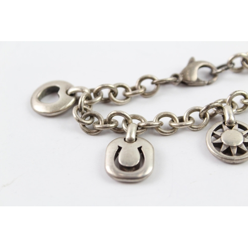 2040 - A Tiffany & Co sterling silver charm bracelet with cut work charms - approx. gross weight 41g