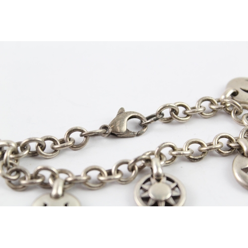 2040 - A Tiffany & Co sterling silver charm bracelet with cut work charms - approx. gross weight 41g