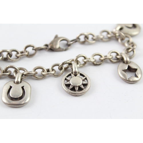 2040 - A Tiffany & Co sterling silver charm bracelet with cut work charms - approx. gross weight 41g