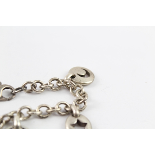 2040 - A Tiffany & Co sterling silver charm bracelet with cut work charms - approx. gross weight 41g