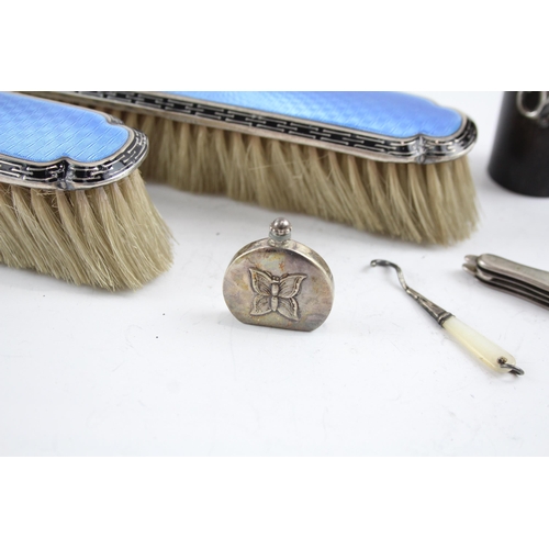 2171 - Seven sterling silver lady's vanity items to include two guilloche enamel hairbrushes, silver pen kn... 