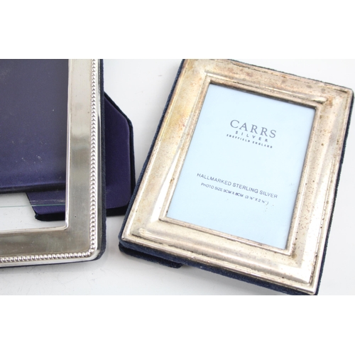 2172 - Three hallmarked sterling silver photo frames - largest approx. 22.5cm x 17.5cm