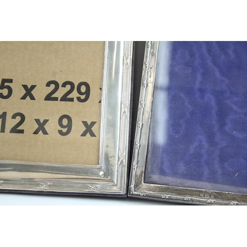 2180 - Three hallmarked sterling silver photo frames - largest approx. 25cm x 20cm