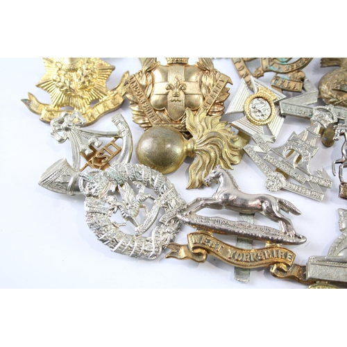 2241 - A collection of military cap badges