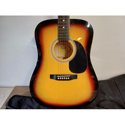 756 - A TGI padded gig bag containing Squier by Fender SA-105 sunburst dreadnought steel-strung acoustic g... 