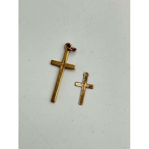 2085E - Two hallmarked 9ct gold cross pendants - approx. gross weight 1.1g