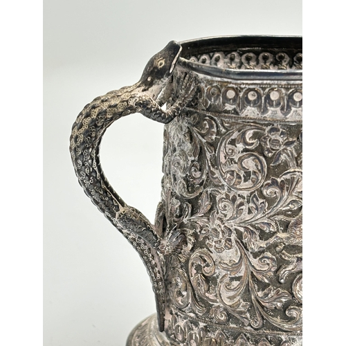 2158 - A late 19th century Indian Oomersi Mawji of Bhuj silver repoussé tankard with embossed elephant, hun... 