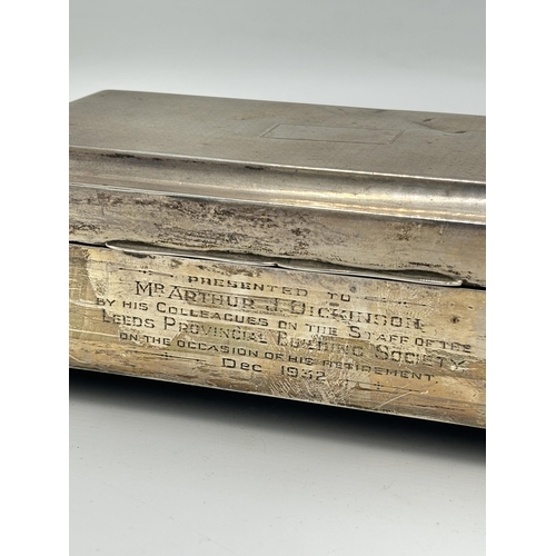 2163 - A hallmarked Birmingham silver rectangular presentation cigarette box on footed base, dated 1929 -ap... 