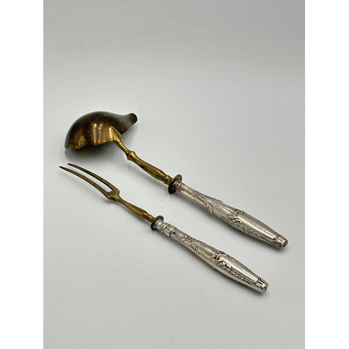 2203C - Two pieces of French .800 silver handled cutlery, one sauce ladle and one pickle fork