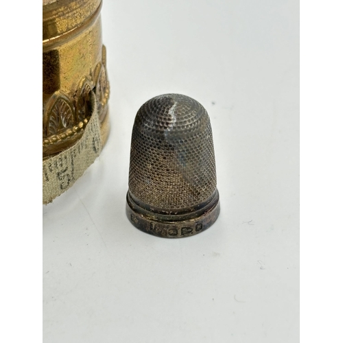 2223 - Two sewing accessories, one Victorian brass thimble holder with tape measure and one hallmarked Ches... 