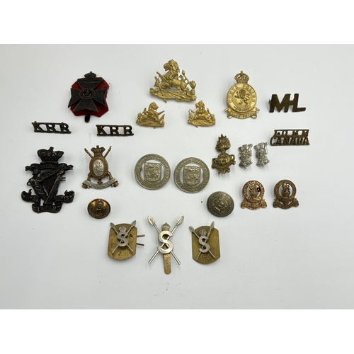 2292 - A collection of military cap badges, shoulder titles and buttons to include Kenya Police, British So... 