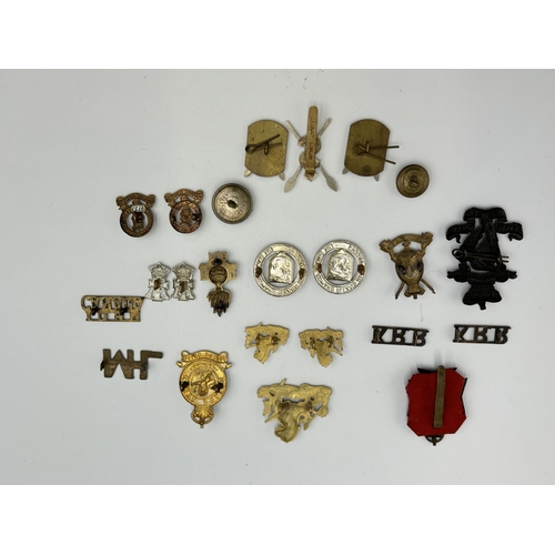 2292 - A collection of military cap badges, shoulder titles and buttons to include Kenya Police, British So... 