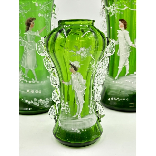 301 - Three Victorian Mary Gregory hand painted green glass vases - largest approx. 28cm high