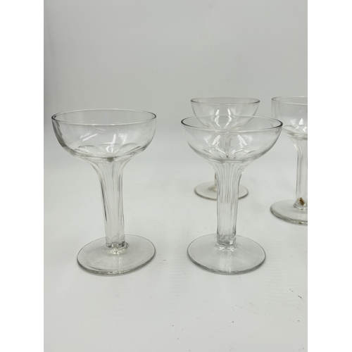 308 - Five early 20th century fluted stem champagne glasses - largest approx. 12.5cm high