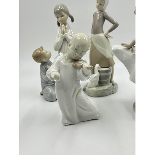 314 - Four Lladro porcelain figurines - largest approx. 24cm high