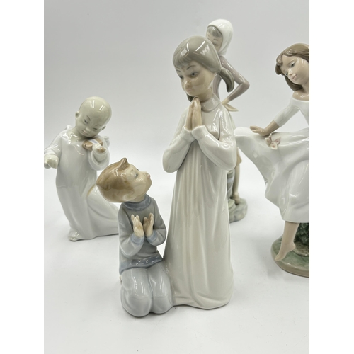 314 - Four Lladro porcelain figurines - largest approx. 24cm high