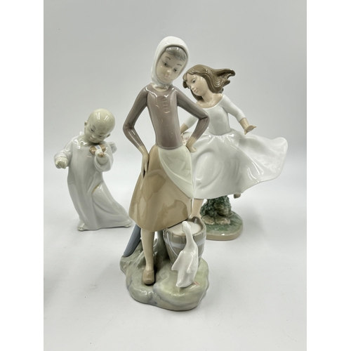 314 - Four Lladro porcelain figurines - largest approx. 24cm high