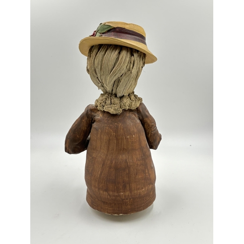 324 - A studio pottery sculpture of a lady wearing hat with impressed 