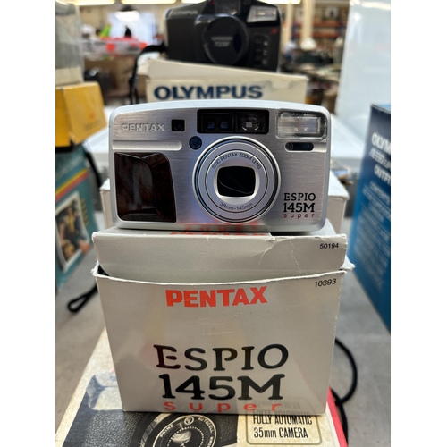 728 - A collection of boxed cameras to include Olympus Superzoom 700BF, Pentax Espio 145M Super, Polaroid ... 