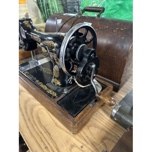 822 - A cased 1934 Singer 128K hand-crank sewing machine with a bag containing patterns