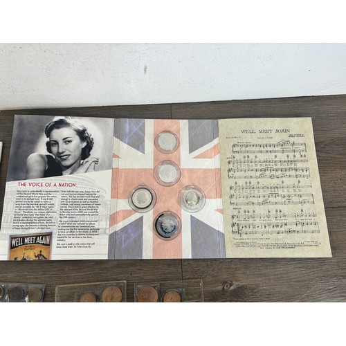 2219 - A cash tin containing mostly British coins to include Beatrix Potter 50p five-coin album, Dame Vera ... 