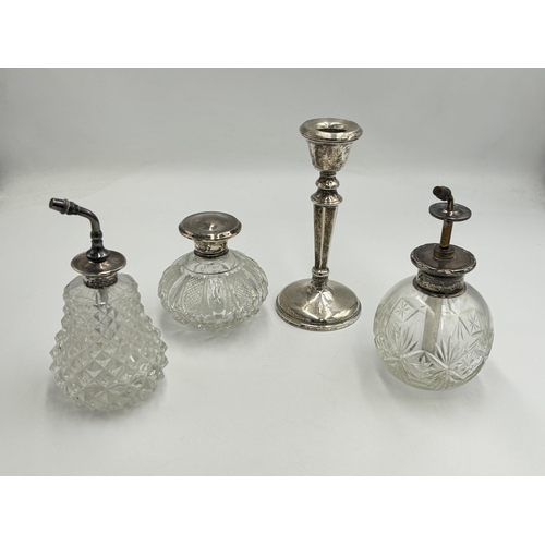 2283 - Four hallmarked sterling silver items, one weighted candlestick - approx. gross weight 195g, one cut... 