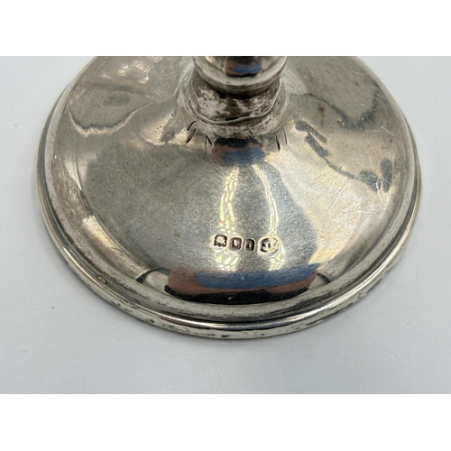 2283 - Four hallmarked sterling silver items, one weighted candlestick - approx. gross weight 195g, one cut... 