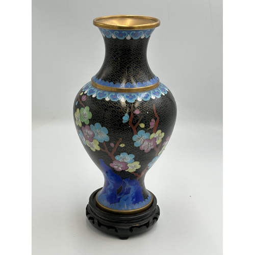 2291 - Three Chinese cloisonné items, one 23cm vase with stand and two jars and covers