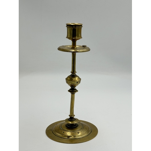 2292 - An Arts & Crafts etched brass candlestick with inset blue cabochon stone - approx. 20cm high