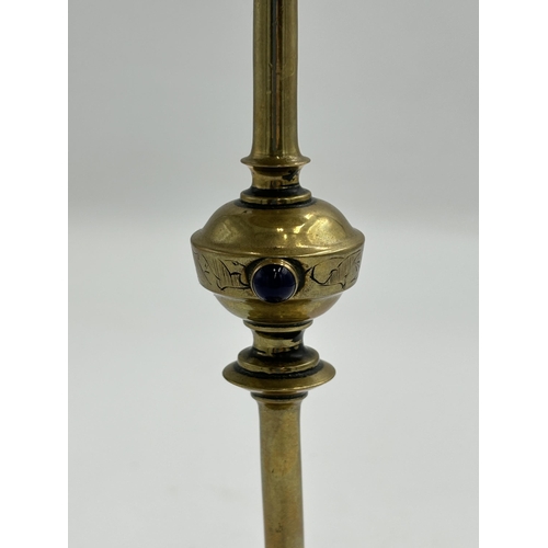 2292 - An Arts & Crafts etched brass candlestick with inset blue cabochon stone - approx. 20cm high