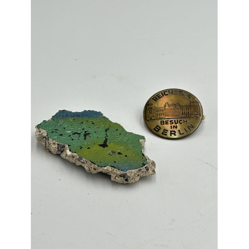 2298 - Two items, one German Reichstag visit in Berlin brass badge and one piece of the Berlin wall