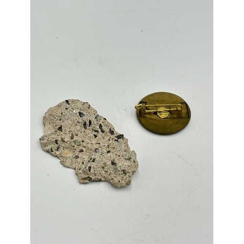 2298 - Two items, one German Reichstag visit in Berlin brass badge and one piece of the Berlin wall