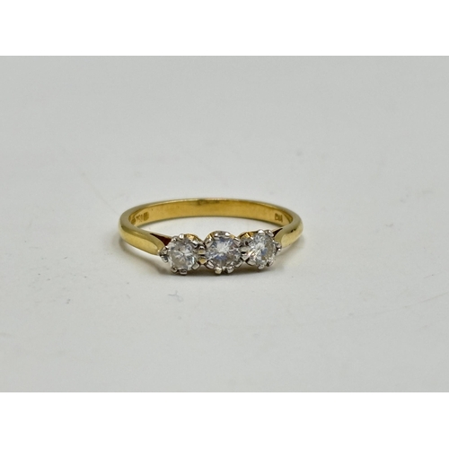 2133I - A hallmarked 18ct gold 0.5ct three stone diamond ring, size Q - approx. gross weight 2.7g