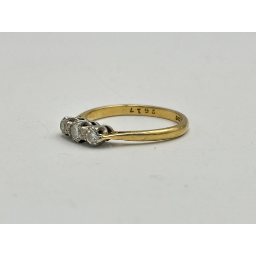 2133J - A hallmarked 18ct gold three stone diamond ring, size O - approx. gross weight 2.6g