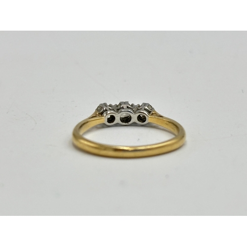 2133J - A hallmarked 18ct gold three stone diamond ring, size O - approx. gross weight 2.6g