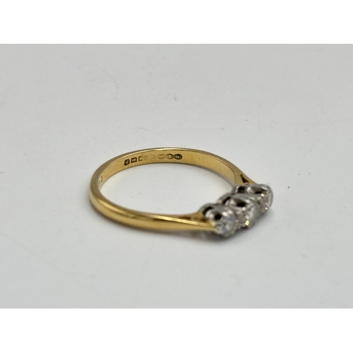 2133J - A hallmarked 18ct gold three stone diamond ring, size O - approx. gross weight 2.6g