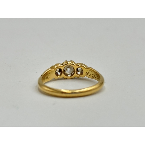 2133S - A hallmarked 18ct gold diamond three stone ring, size M - approx. gross weight 3.3g