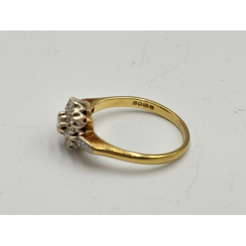 2133U - A hallmarked 18ct gold diamond daisy ring, size O - approx. gross weight 3.25g