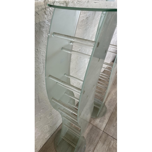 31 - A pair of contemporary glass CD racks - approx. 111cm high