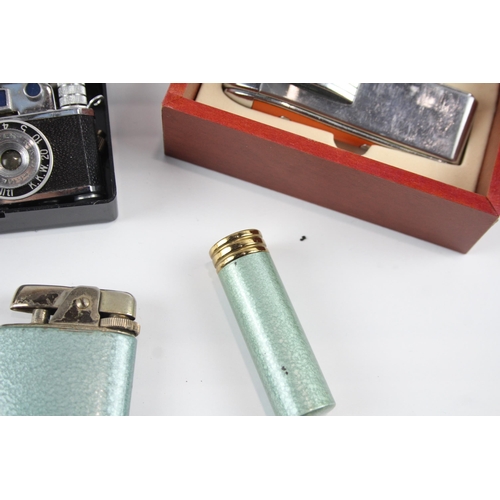 2264 - Four vintage novelty cigarette lighters