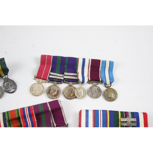 2285 - Five mounted miniature medal groups to include WWI trio, WWII, Elizabeth II B.E.M. Silver Jubilee et... 