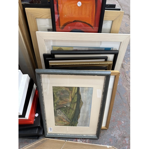 1129 - A large quantity of framed pictures and canvases