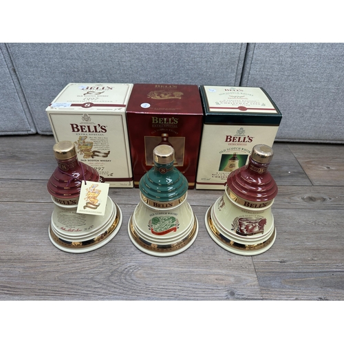 606B - Three boxed 70cl Wade Christmas decanters of Bell's Extra Special Old blended Scotch whisky, 1996, 1... 