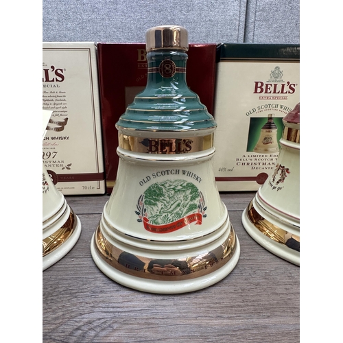 606B - Three boxed 70cl Wade Christmas decanters of Bell's Extra Special Old blended Scotch whisky, 1996, 1... 