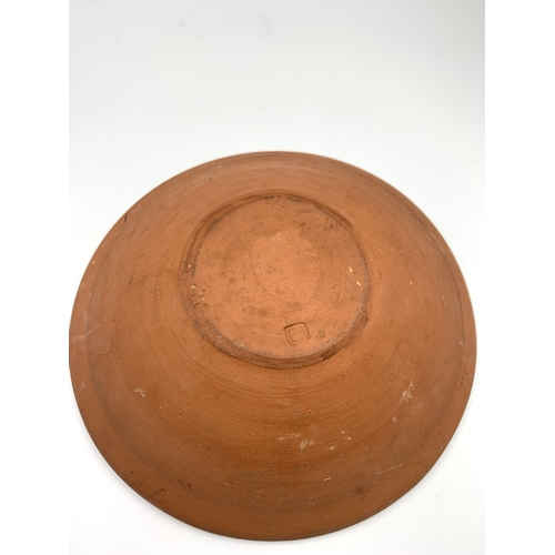 375C - A mid 20th century studio pottery circular bowl hand decorated with fish design and impressed 