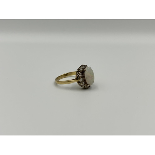 2134A - An 18ct gold opal and diamond halo ring, size M½ - approx. gross weight 4g