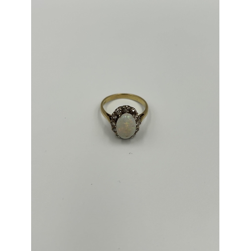 2134A - An 18ct gold opal and diamond halo ring, size M½ - approx. gross weight 4g